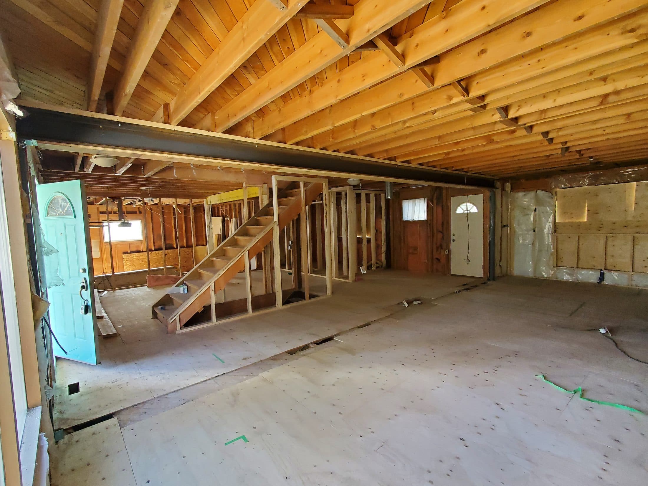 Main floor opened up with a steel beam carrying the load where the bearing wall was removed