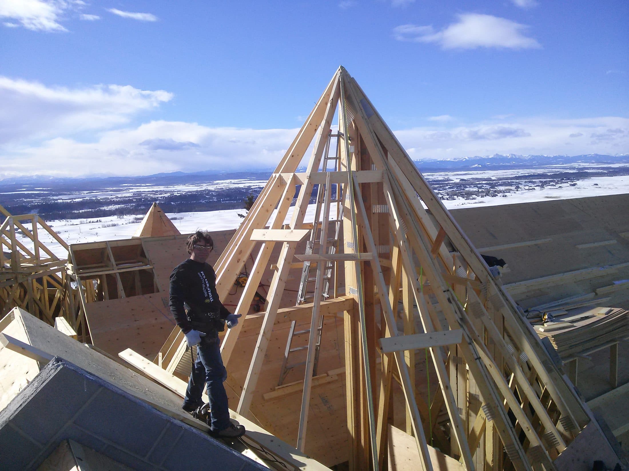 Framing a pyramid turret roof with the Alberta foothills behind