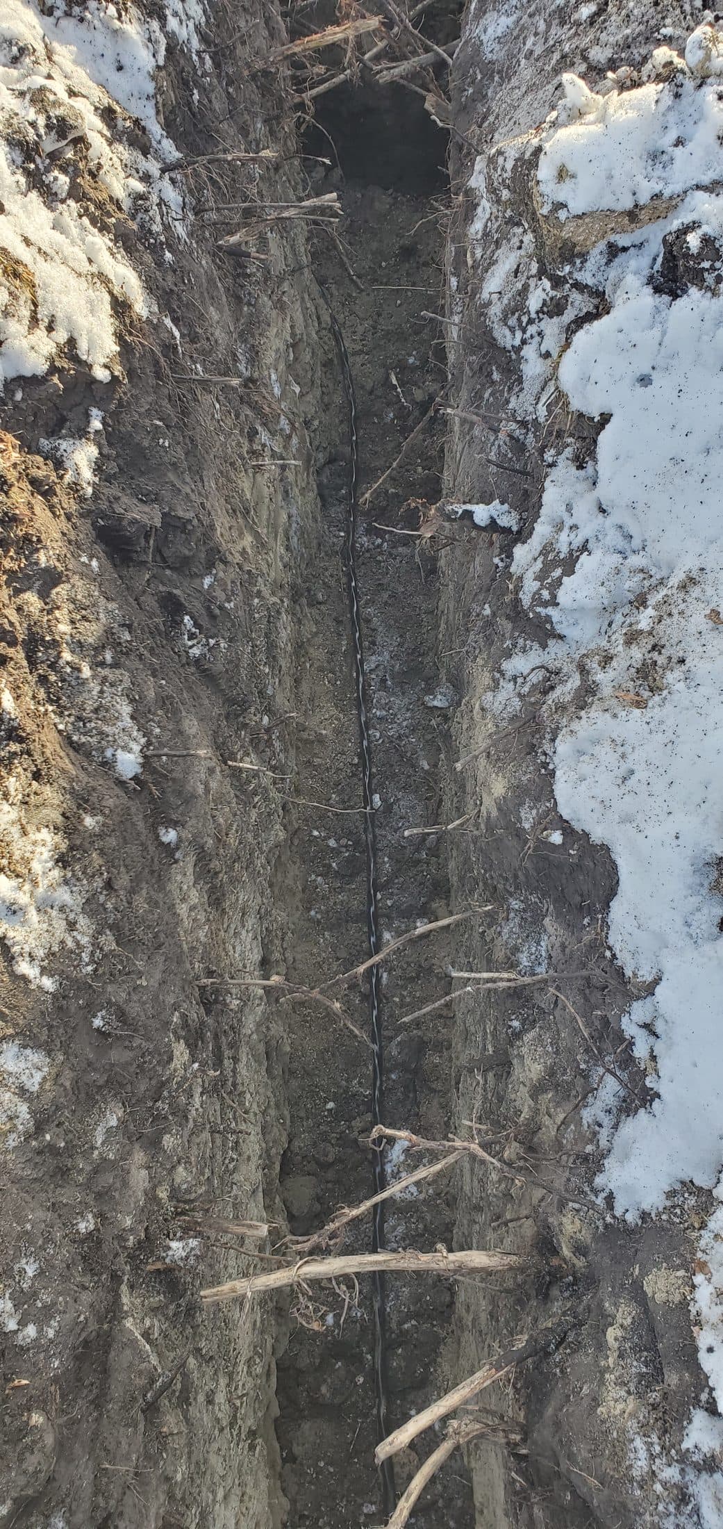 New conduit laid in the bottom of a freshly dug trench
